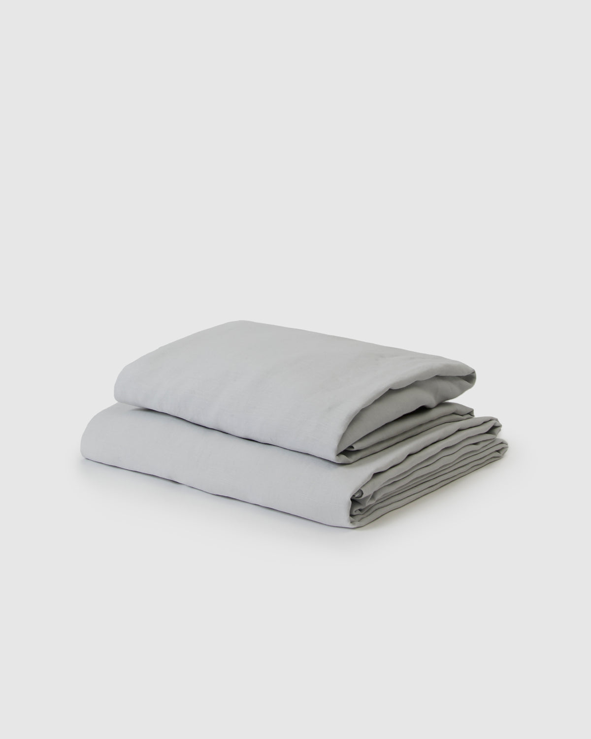 Side angle shot of light blue glacier flat and fitted sheet set