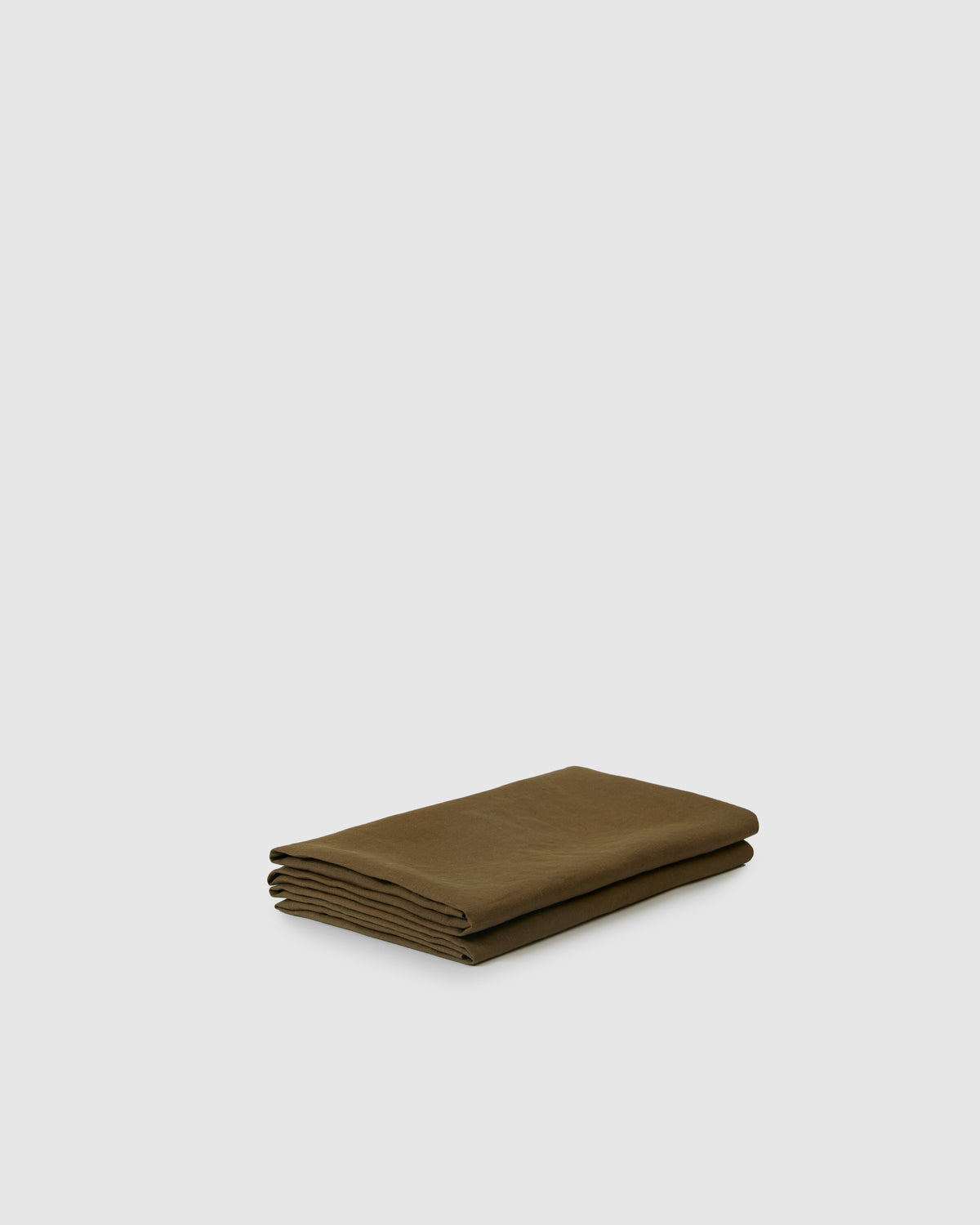 Side angle shot of moss green pair of pillowcases