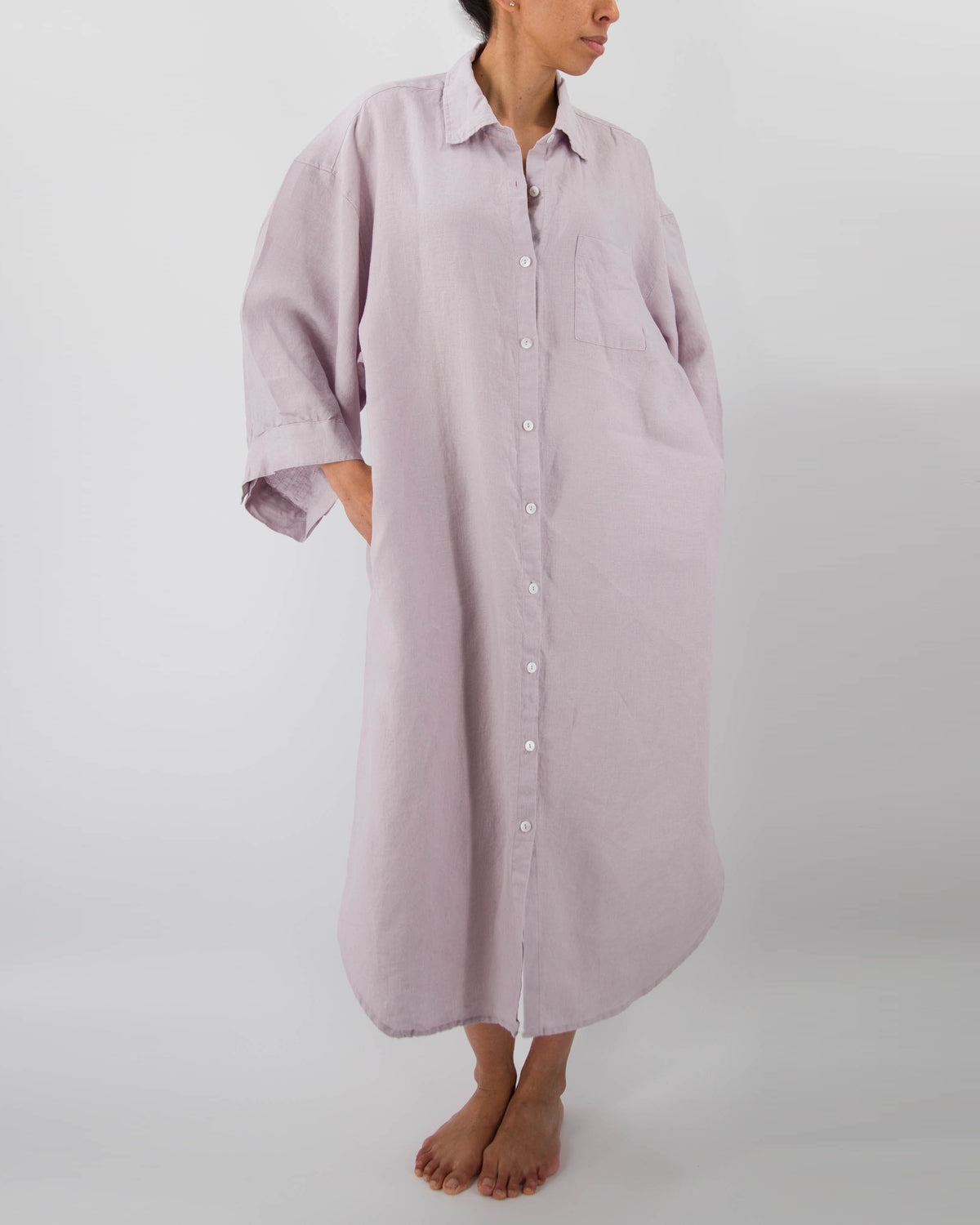 Front photo of model with full-length linen dress with buttons and front pocket in lilac purple