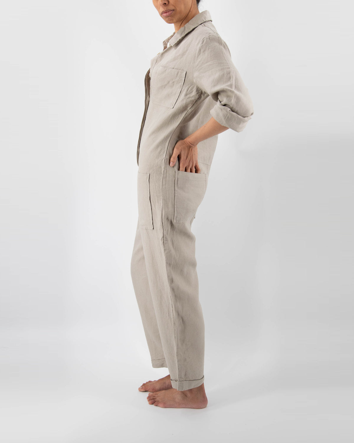 Side of model in taupe linen jumpsuit