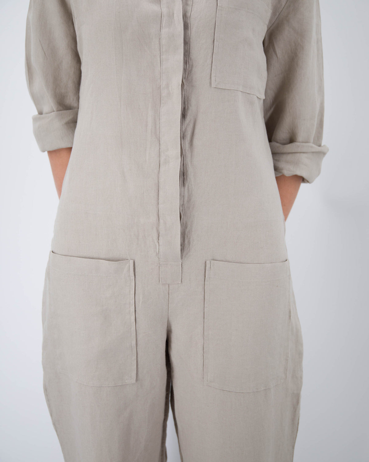 Close up of torso of model in taupe linen jumpsuit