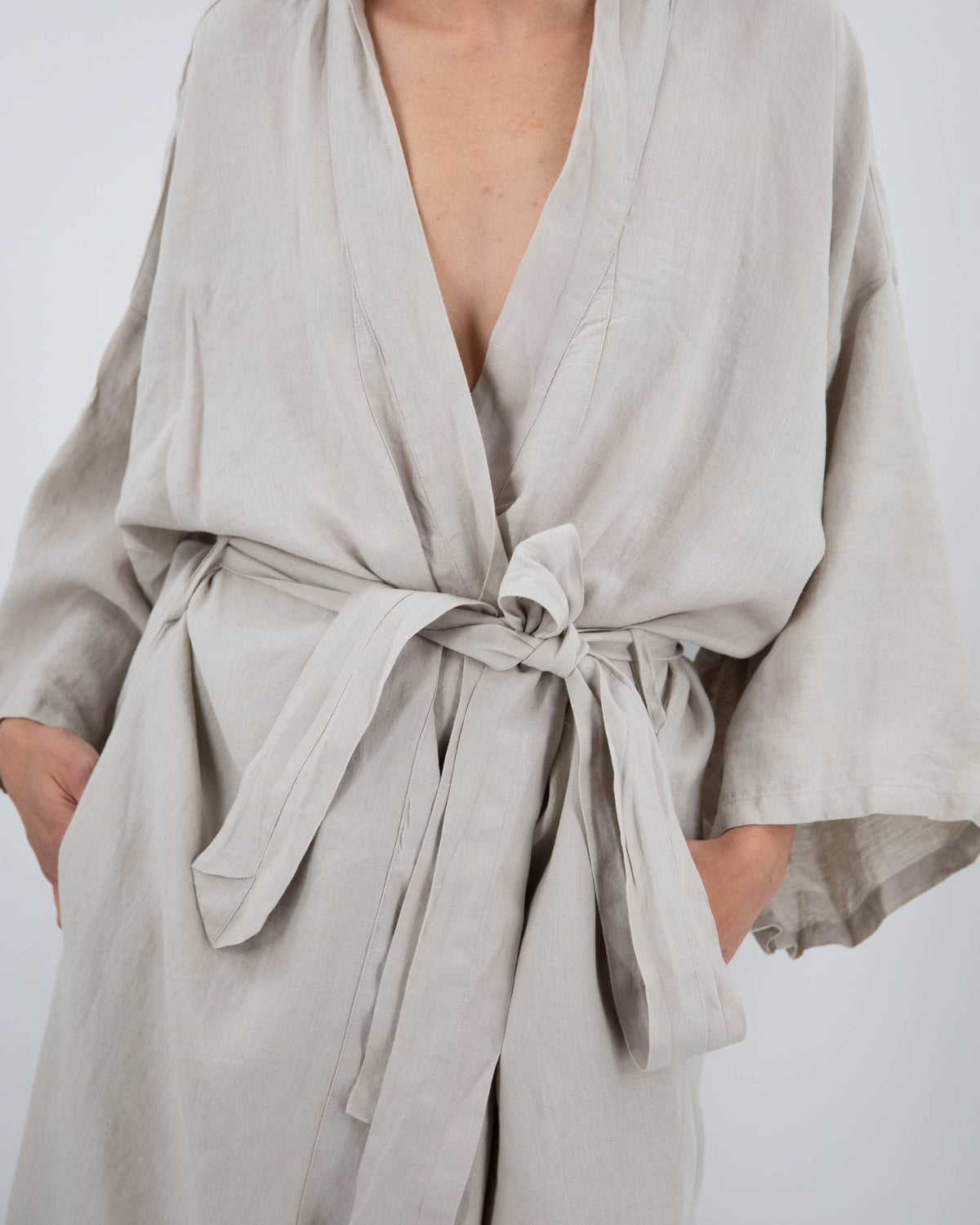 Close up of full-length linen robe in dove gray on model