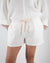 Dove gray linen shorts with drawstring tie on model