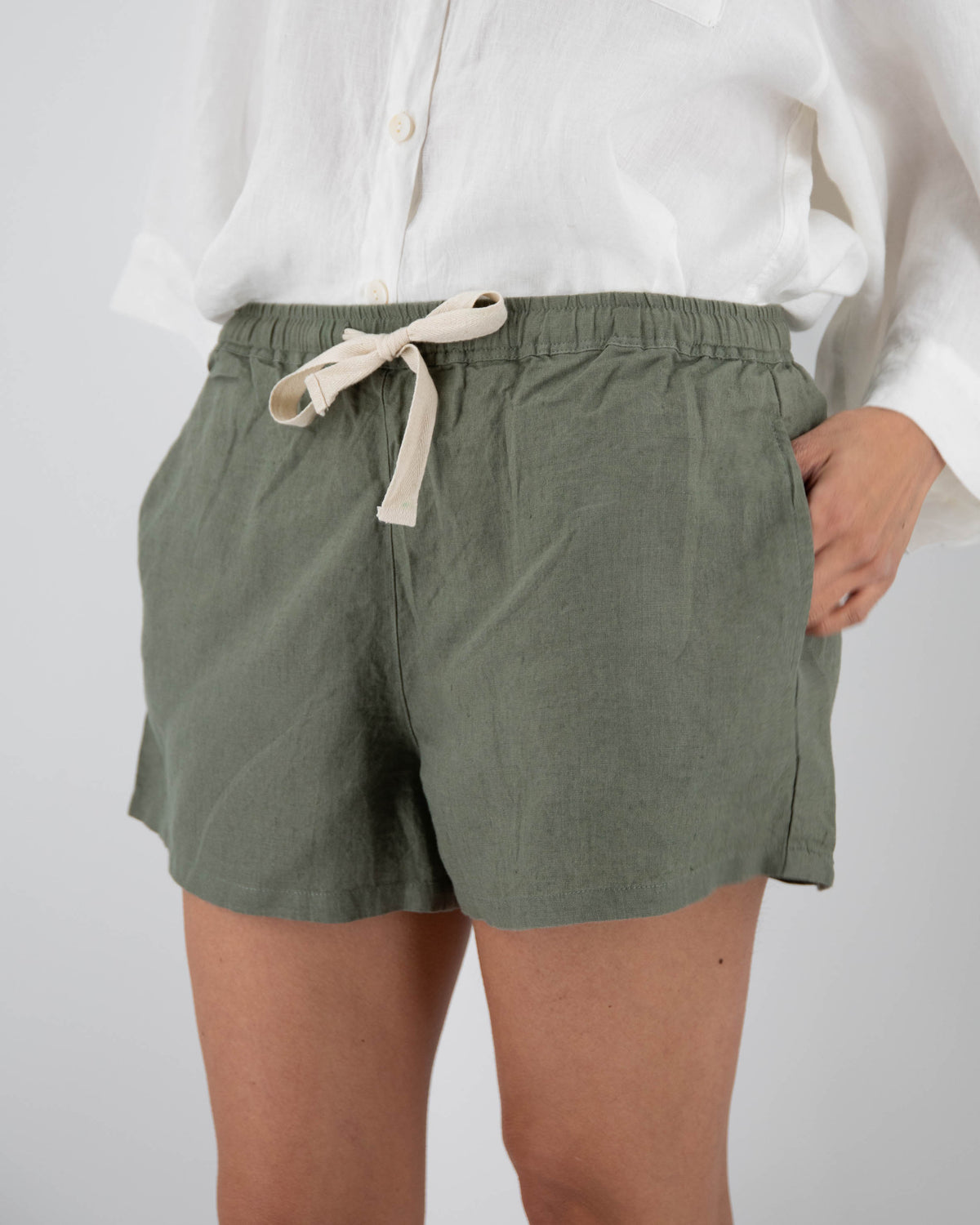 Khaki green linen shorts with drawstring tie on model