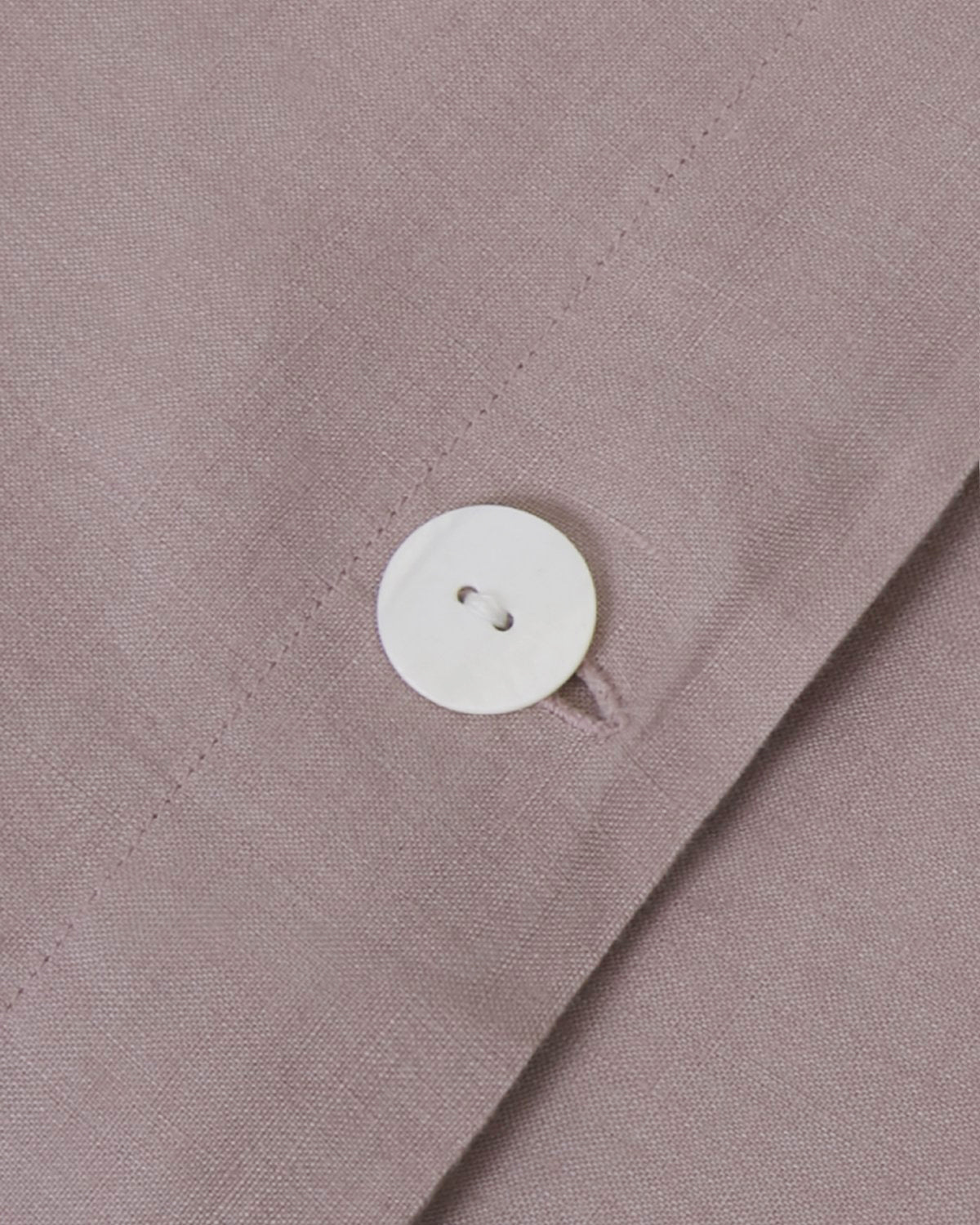 Side angle shot of linen duvet cover and pair of pillowcases in dark orchid pink