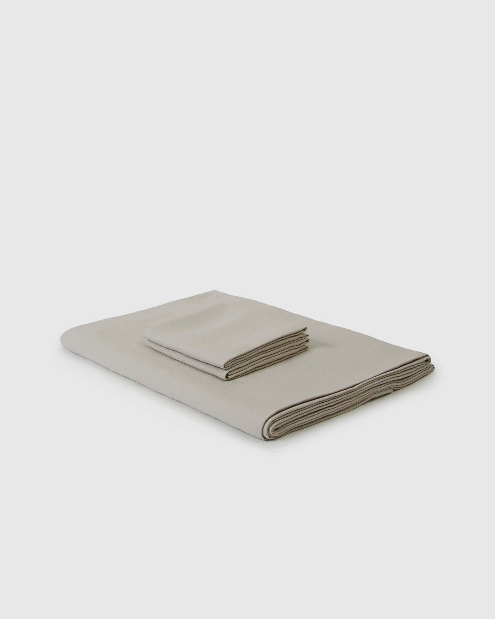 Side angle shot of linen duvet cover and pair of pillowcases in light dove gray