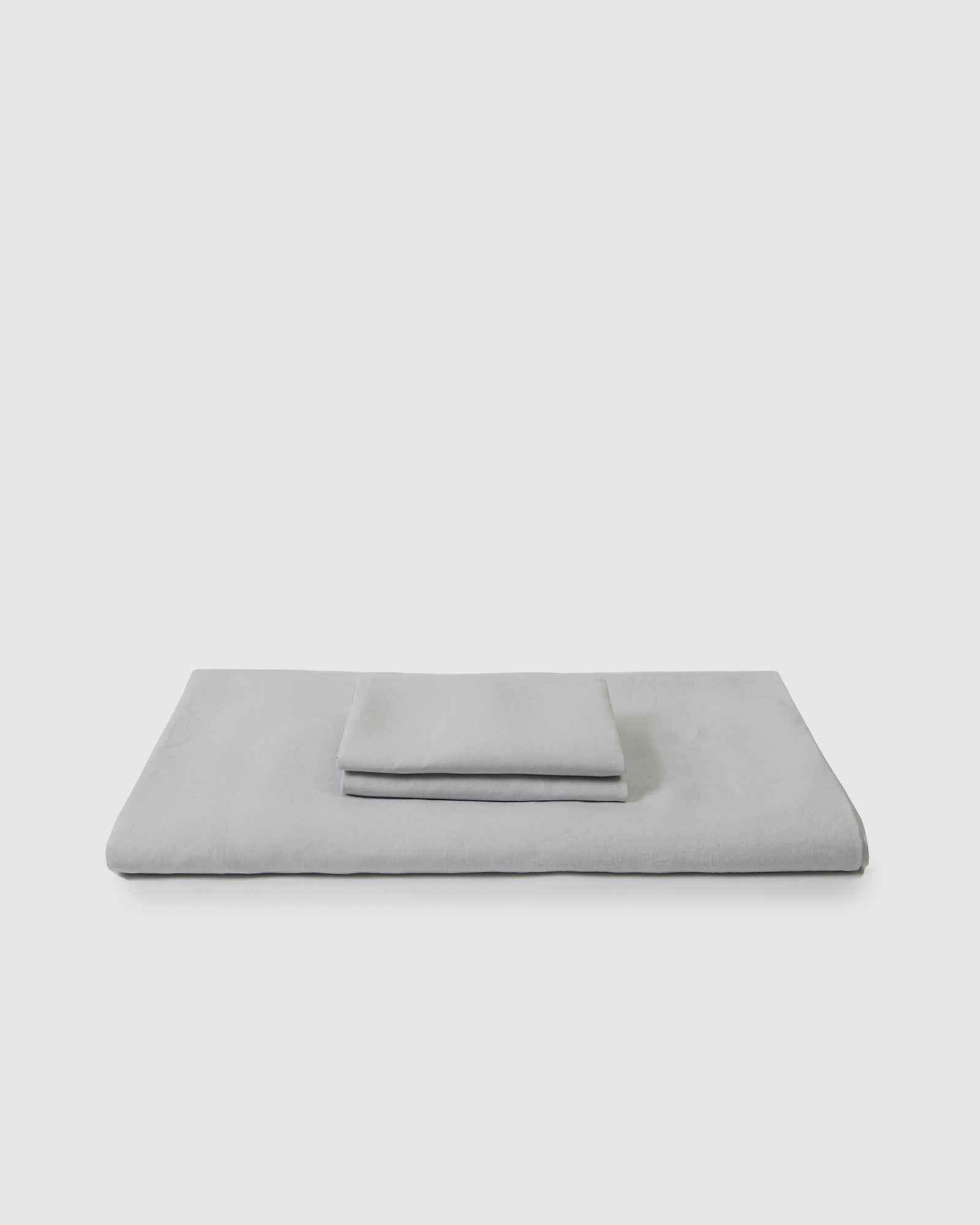 Side angle shot of linen duvet cover and pair of pillowcases in light blue glacier