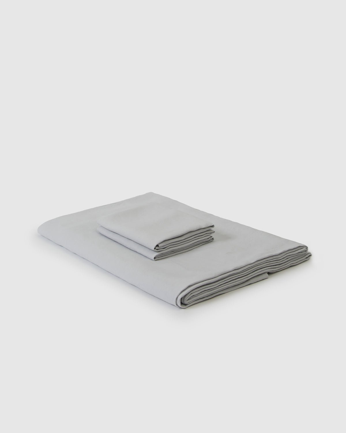 Side angle shot of linen duvet cover and pair of pillowcases in light blue glacier