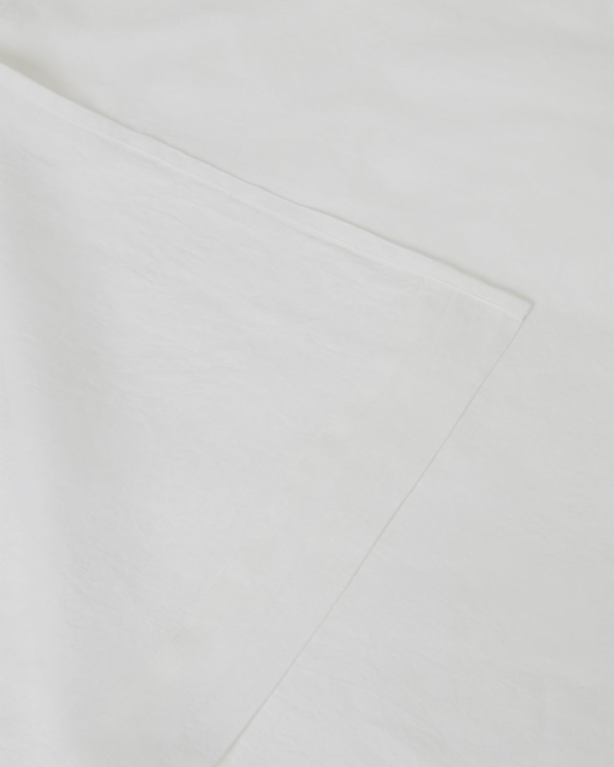 Image of creamy white milk flat and fitted sheet set