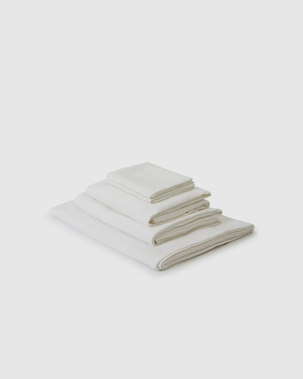 Side angle shot of a creamy white milk sheet set