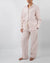 Model in pink linen striped pajamas (long sleeved shirt and long pants) 