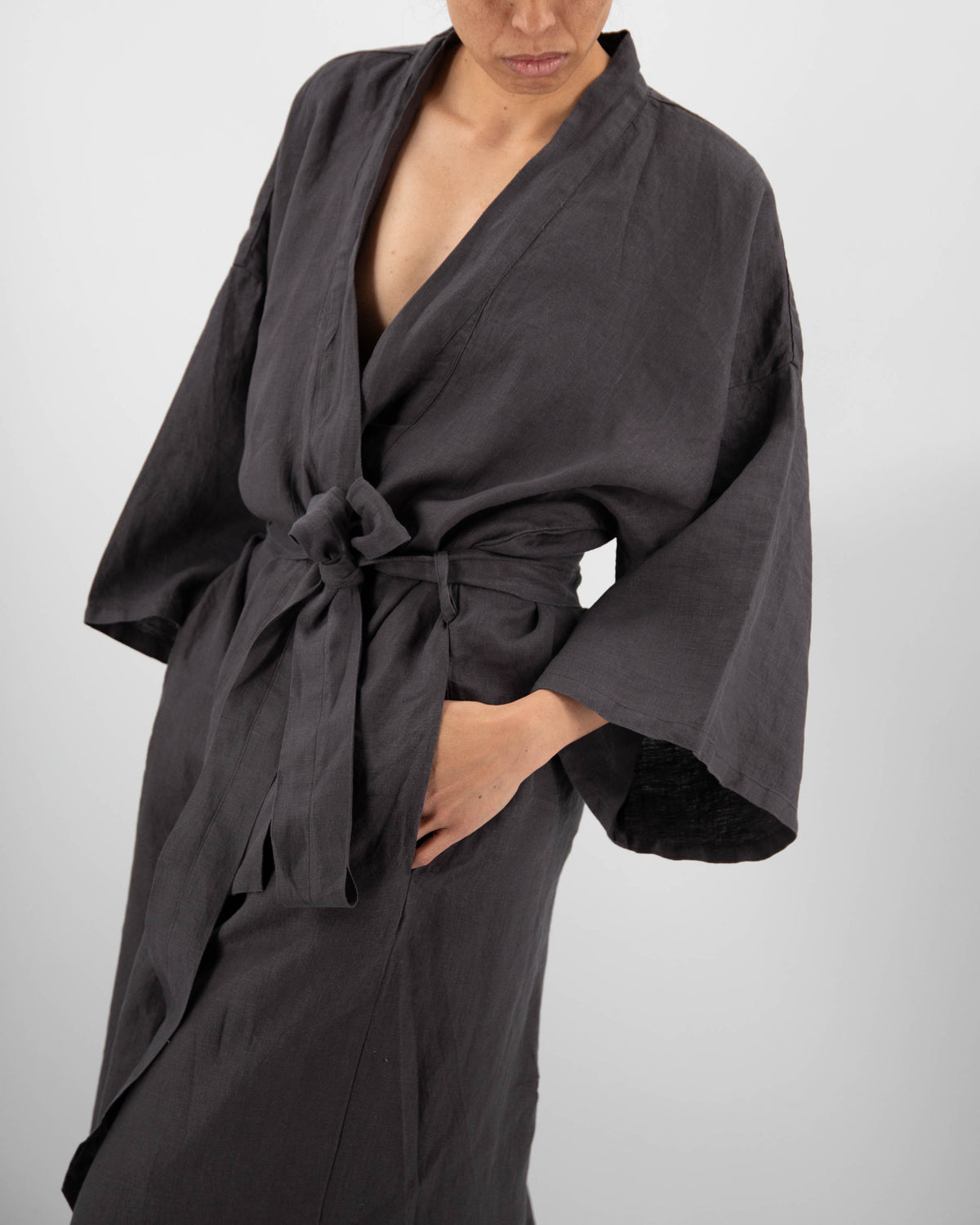 Close-up of lull-length linen robe in charcoal black on model